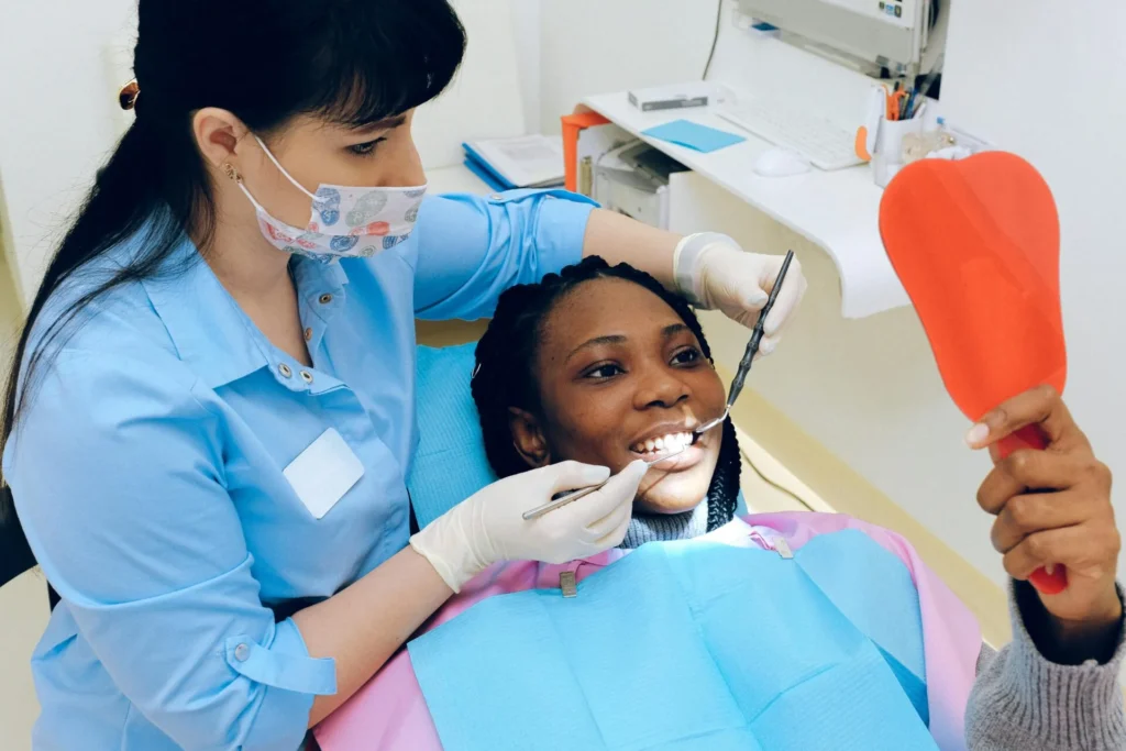 pexels-photo-3845653-3845653 A female dentist checks a patient's teeth during a dental appointment.