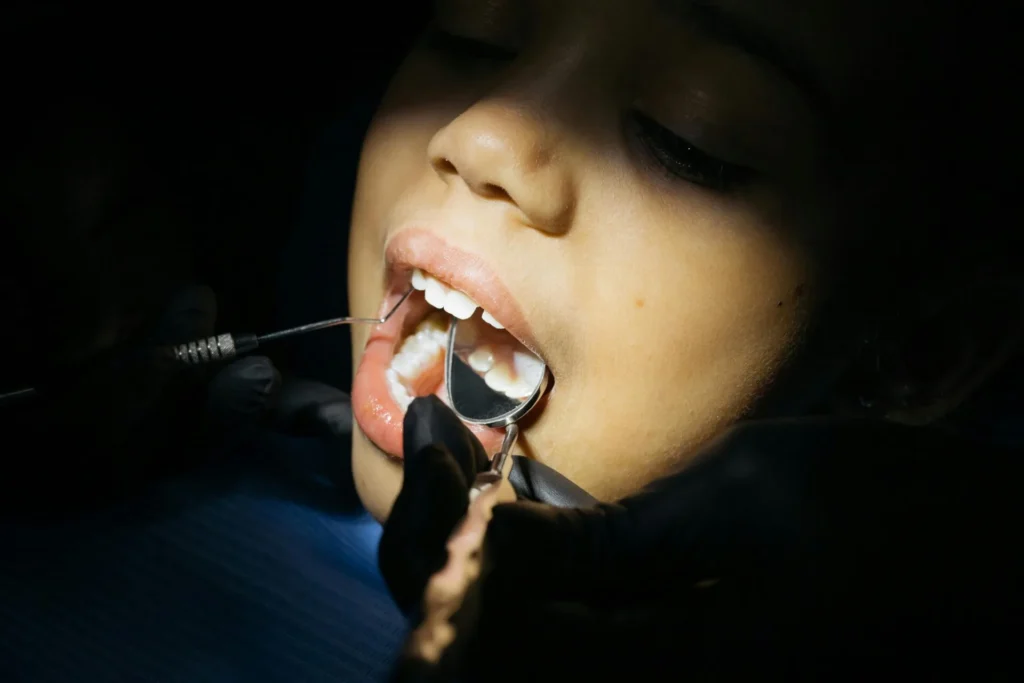 pexels-photo-6502552-6502552 Close-up of a child undergoing a dental examination at a clinic.